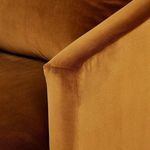 Detailed view of armrest angle and velvet upholstery showing rich burnt orange color