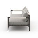 Close-up side view of Sherwood sofa armrest with light rope weaving detail and textured fabric cushions