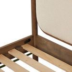 Side close-up on bed frame wood showing slats and leg connection with smoked oak finish
