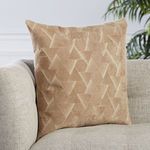 Pillow placed on beige textured fabric sofa highlighting its size and texture