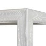 Close-up of top corner joint highlighting hand-coved frame details and woodgrain