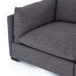 Back of sectional highlighting even cushion height and minimalist design in charcoal fabric