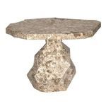 Front angled view of the full marble table emphasizing its faceted base and thick stone top