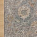 Corner detail of Louisa Ocean Sunset Rug showing intricate floral pattern and soft tones on light wood floor