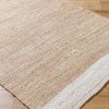 Close-up of Kamey Sandstone Rug corner showing tight weave and sandy brown and off-white color border