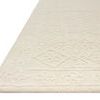 Close-up angle showing the thick wool pile and edge detail of the ivory Cecelia rug