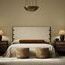 Styled bedroom setting with Bennett Chair placed near bed and wooden nightstands
