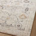 Close-up of rug edge showing floral details and subtle color variations on hardwood floor