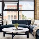 Close-up of sectional arm and cushion with smooth charcoal color and fabric texture visible