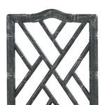 Detailed close-up of fretwork pattern with carved bamboo-style frame on the chair back