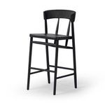 Slightly angled front view capturing seat depth and backrest curve of the Buxton Drifted Oak Bar Stool in black finish