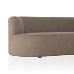 Close-up of curved armrest and sculpted upholstery on sectional sofa.