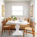 Darling Olive rug in a bright dining nook with white pedestal table and wooden chairs