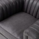 Side seam and base corner detail showing leather grain and construction quality
