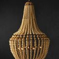 Penelope Beige Chandelier against dark wall, showing full side profile with illuminated bulbs