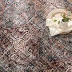 Close-up angled view of Zakaria rug with light round tray and cream vase on top