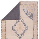 Back of rug partially flipped, revealing contrasting dark gray machine-washable backing fabric.