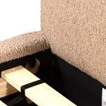 Close-up inside corner connection of camel upholstered frame with wooden slats secured by black strap