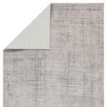 Back side of the rug displaying light cream backing with subtle texture contrast