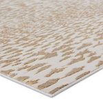 Close-up corner view showing metallic texture and pile height of the ivory and gold pattern