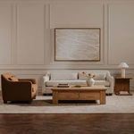 Rora Table Lamp on wooden side table in living room with beige sofa, armchair, coffee table, and abstract wall art