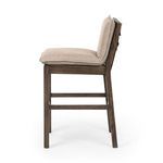 Side profile of Wilmington Stool showing almond wood frame and beige cushioned seat with thick padding