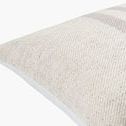 Close-up of pillow corner showing textured woven fabric and smooth white piping along edge