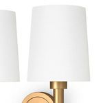 Close-up of top edge of white linen shade and brass holder from slightly different angle
