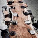 Benji Stool in black included at a mix of rustic and modern seating around a natural wood dining table