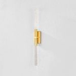 Millerton Wall Sconce illuminated with warm light highlighting seedy glass bubbles and wall shadow