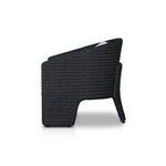 Close corner glimpse of thick seat cushion and tightly woven wicker frame
