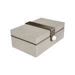 Angled top view highlighting textured shagreen and brass strap with white knob on the side.