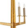 Close-up detail of textured gold arm and candle-style bulbs without shades