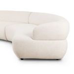 Close-up of curved armrest and backrest corner showing plush fabric and seamless design