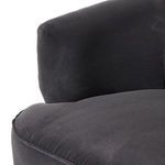 Detailed close-up of armrest showing smooth fabric and piping along the edge