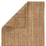 corner fold detail showing front and back textures of woven taupe jute area rug
