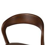 Close-up of the backrest's inner curve and wood grain texture
