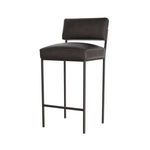 Side angled view of graphite leather bar stool showing cushioned seat profile and sleek metal legs.