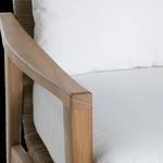 Detailed view of smooth teak wood armrest and upper frame edge