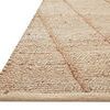 Close-up side angle showing the rug’s braided jute edge and thick natural fiber texture