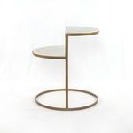 Side profile highlighting slim bronze metal frame and the offset spacing between the two marble shelves