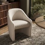 Levi Boucle Dining Chair in cream shown in styled room with wood sideboard and round table