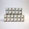 Front view of stacked boxes emphasizing matching geometric bone inlay on both sizes