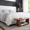 Side angle of Kenzie Ivory Charcoal rug in bedroom with white bedding, black accent wall, large window view