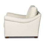 Right side profile showing smooth linen upholstery and gentle arm slope of the chair