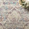 Close-up of rug’s central pattern with bowl of greenery layering natural styling