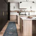 Long narrow runner version of Giada Denim rug styled in modern kitchen with wooden cabinets and island