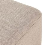 Close-up showing detailed weave of beige performance fabric on ottoman