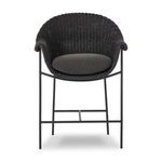 Bottom front detail showing iron footrest bar and slender metal stool legs
