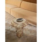 Side angle of Frida Outdoor Side Table styled next to beige sofa with book and tray on top